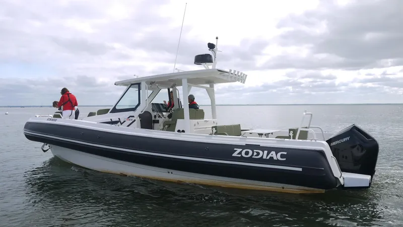 Slide: The Image of 2025 Zodiac X10CC boat with twin Yamaha 450 engines on calm water. - 6