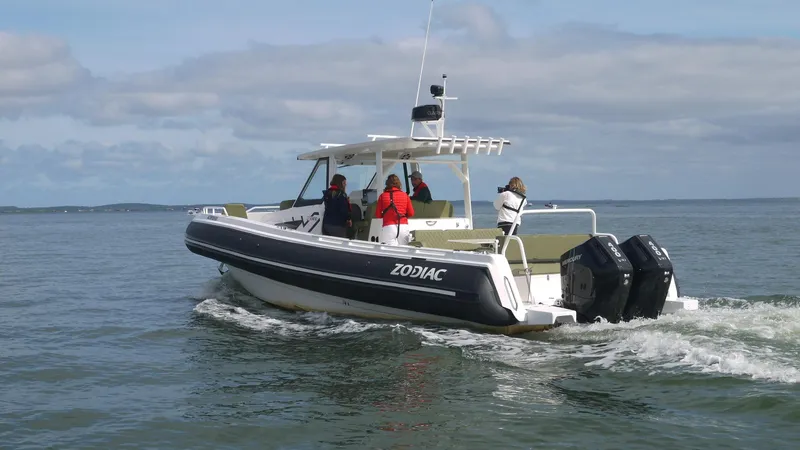 Slide: The Image of Zodiac X10CC boat with twin Yamaha 450 engines cruising on open water, 2025 model. - 7