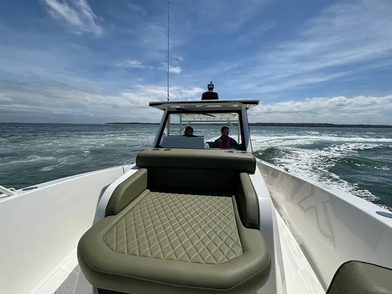 Slide: The Image of 2025 Zodiac X10CC boat cruising on open water, featuring twin Yamaha 450 engines. - 9