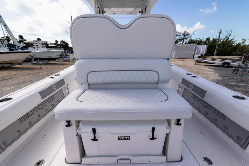 Slide: The Image of 2025 Sea Fox 282 Hybrid LT boat interior with cushioned seating and Yeti cooler. - 11