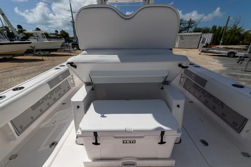 Slide: The Image of 2025 Sea Fox 282 Hybrid LT boat interior with Yeti cooler and seating area. - 13