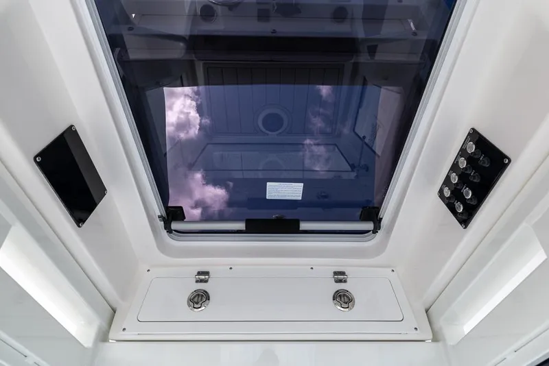 Slide: The Image of Interior view of 2025 Sea Fox 282 Hybrid LT boat, featuring a skylight and control panels. - 19