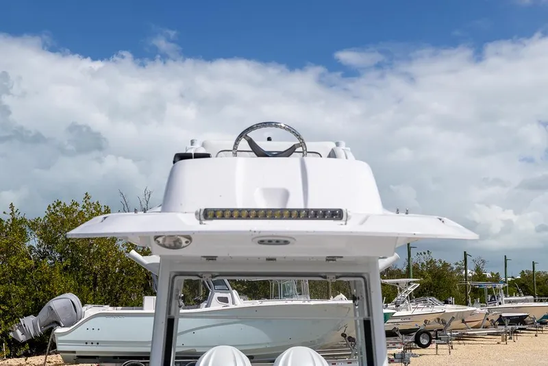Slide: The Image of 2025 Sea Fox 282 Hybrid LT boat, docked with clear sky background. - 24