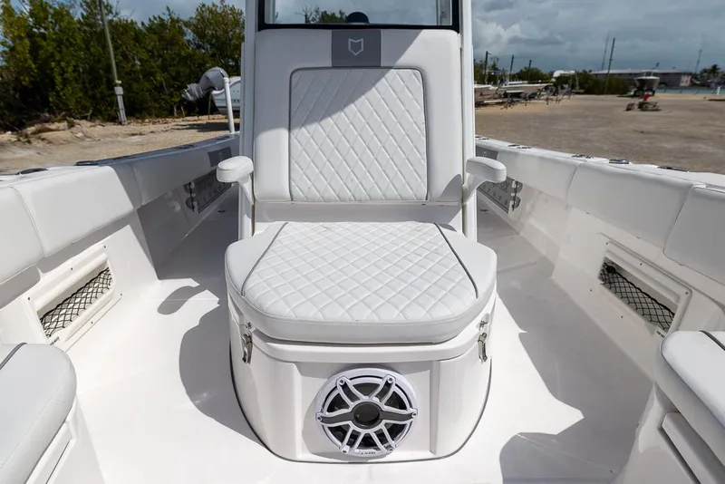 Slide: The Image of 2025 Sea Fox 282 Hybrid LT boat interior with cushioned seating and speaker. - 27