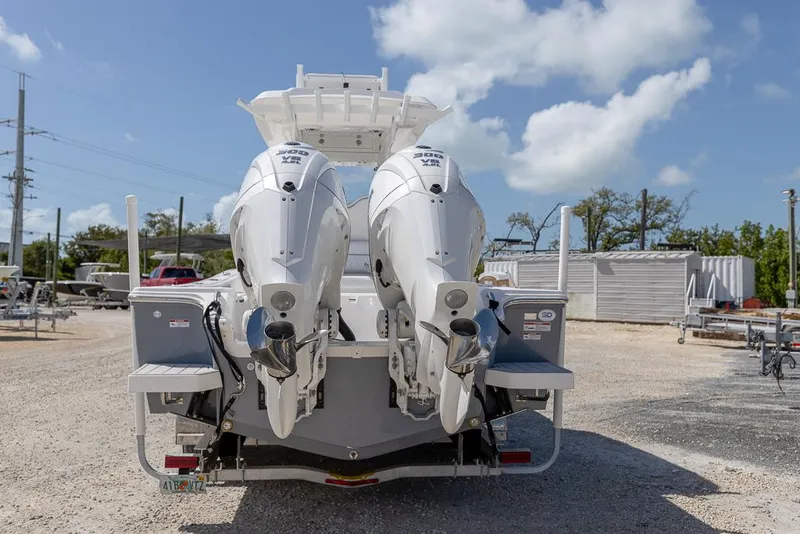 Slide: The Image of 2025 Sea Fox 282 Hybrid LT boat with dual outboard engines, parked outdoors. - 3