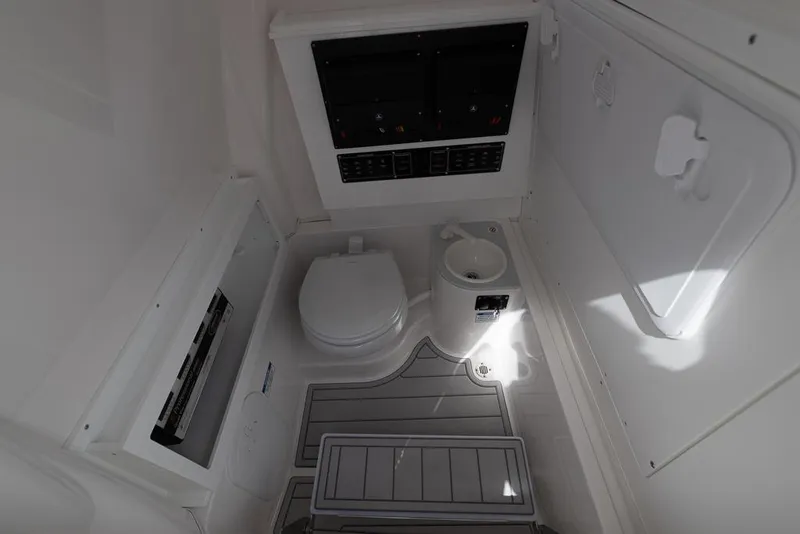 Slide: The Image of Interior of 2025 Sea Fox 282 Hybrid LT boat, featuring a compact marine toilet. - 31