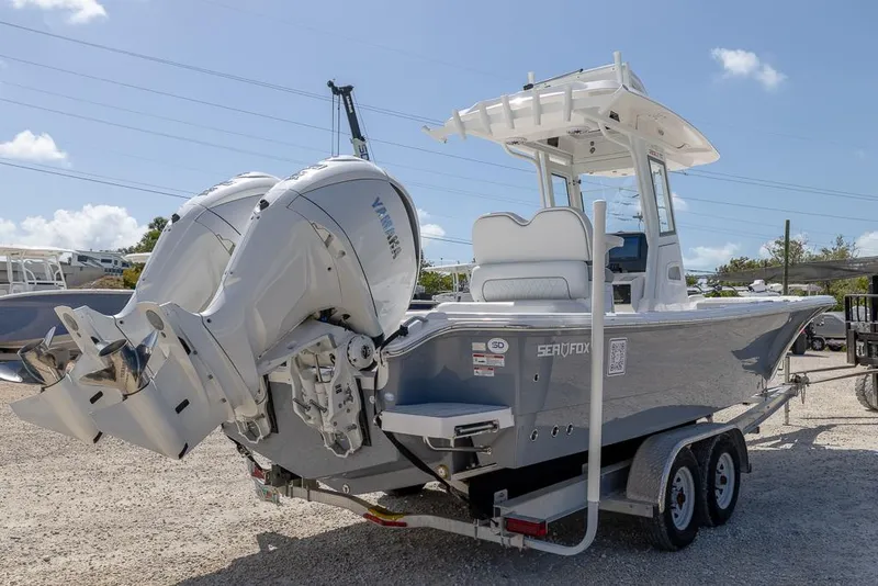 Slide: The Image of 2025 Sea Fox 282 Hybrid LT boat on trailer, featuring dual outboard engines. - 4