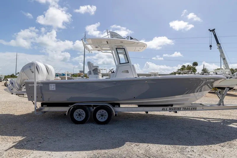 Slide: The Image of 2025 Sea Fox 282 Hybrid LT boat on trailer under clear sky. - 5