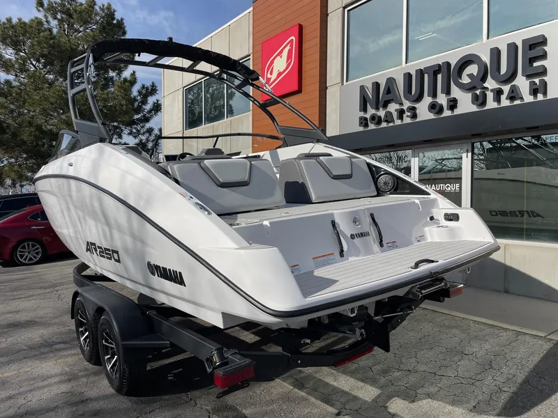 Slide: The Image of 2025 Yamaha AR250 boat on trailer at dealership, Nautique Boats of Utah. - 3
