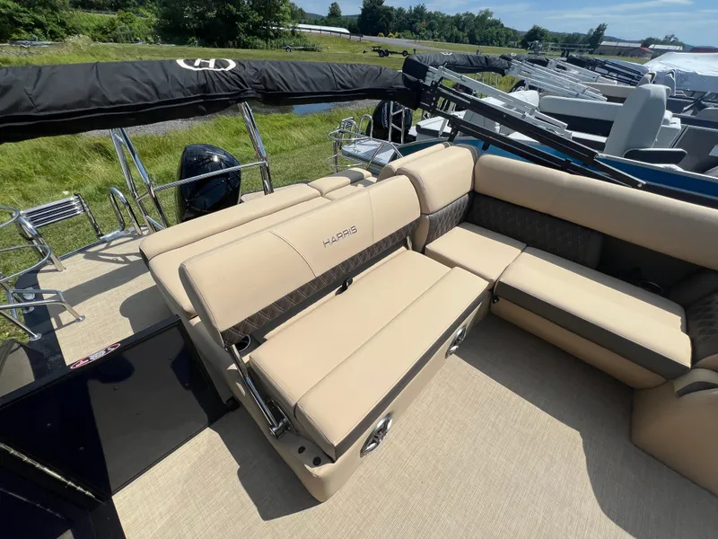Slide: The Image of 2024 Harris Sunliner 230 boat interior with beige seating and sleek design. - 14