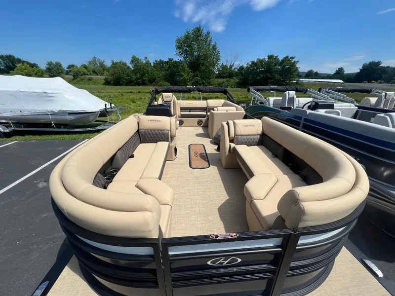 Slide: The Image of 2024 Harris Sunliner 230 pontoon boat with spacious seating and modern design. - 7