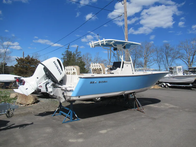 Slide: The Image of 2025 Sea Born LX24 Center Console boat with Honda outboard motor, parked outdoors. - 10