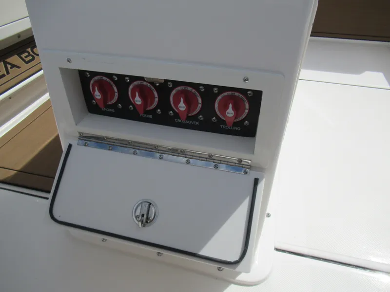 Slide: The Image of 2025 Sea Born LX24 Center Console boat control panel with red switches. - 13