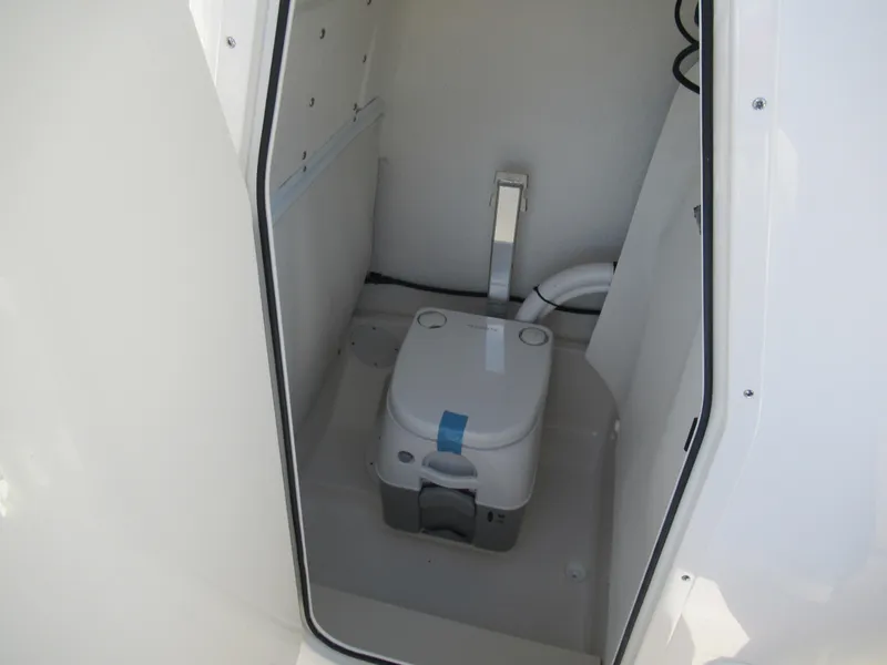 Slide: The Image of 2025 Sea Born LX24 Center Console boat interior with compact marine toilet. - 15