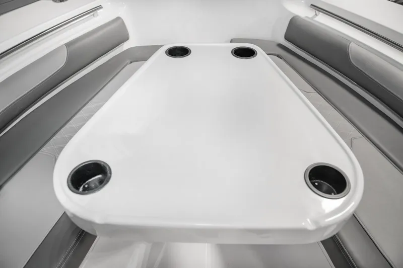 Slide: The Image of 2025 Sea Born LX24 Center Console boat interior with table and cup holders. - 16