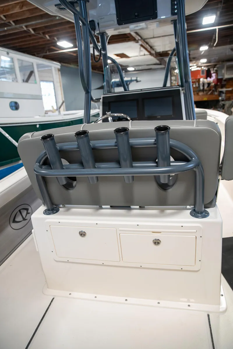 Slide: The Image of 2025 Sea Born LX24 Center Console boat interior with rod holders and storage compartments. - 19