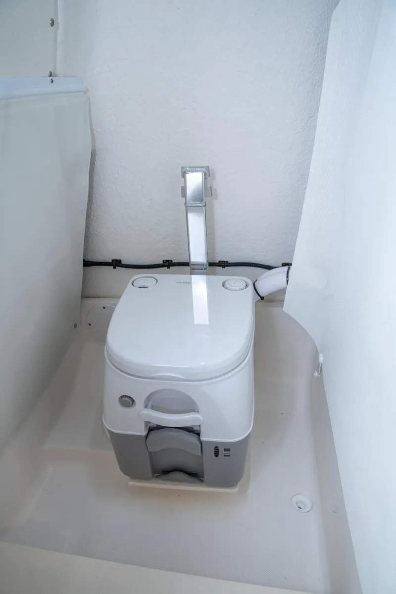 Slide: The Image of Portable toilet in 2025 Sea Born LX24 Center Console boat interior. - 21