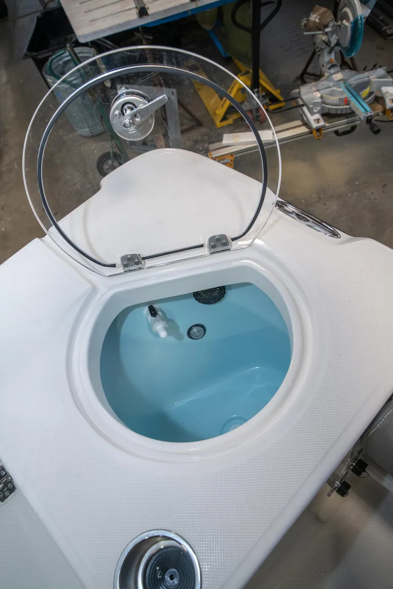 Slide: The Image of 2025 Sea Born LX24 Center Console livewell with open lid, showcasing interior design. - 22