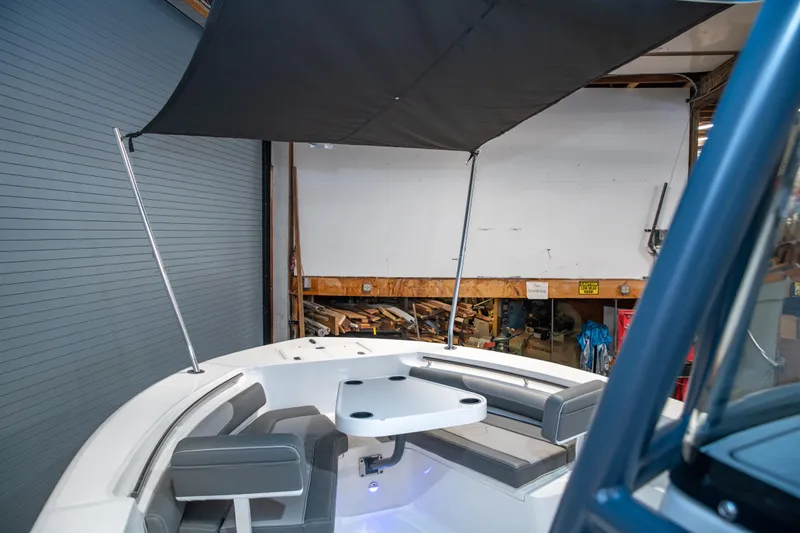 Slide: The Image of 2025 Sea Born LX24 Center Console boat interior with seating and canopy. - 25