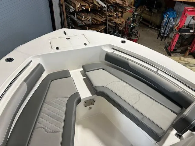 Slide: The Image of 2025 Sea Born LX24 Center Console boat interior with gray seating in a storage area. - 5