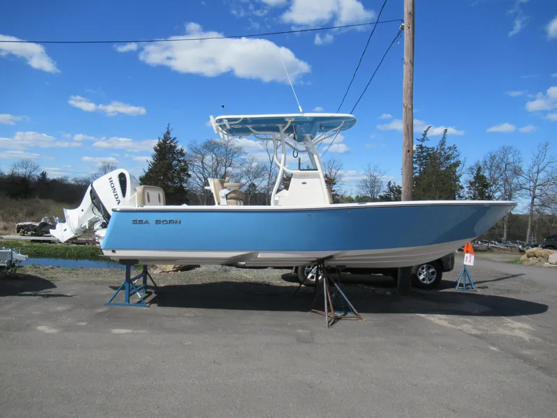 Slide: The Image of 2025 Sea Born LX24 Center Console boat on display under a clear blue sky. - 9