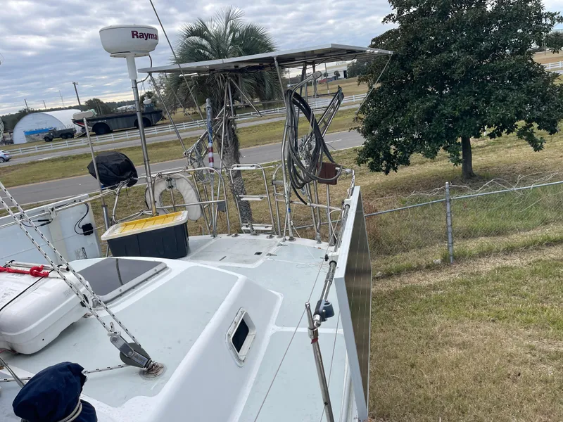 Slide: The Image of 1985 Gulfstar 45 Hirsch Center Cockpit sailboat docked near a road and trees. - 12