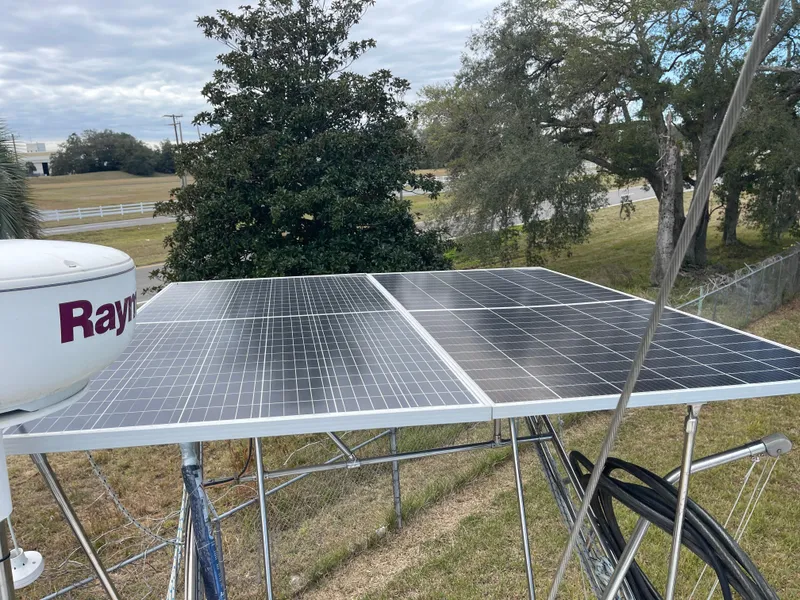 Slide: The Image of Solar panels on a 1985 Gulfstar 45 Hirsch Center Cockpit sailboat, surrounded by trees. - 17
