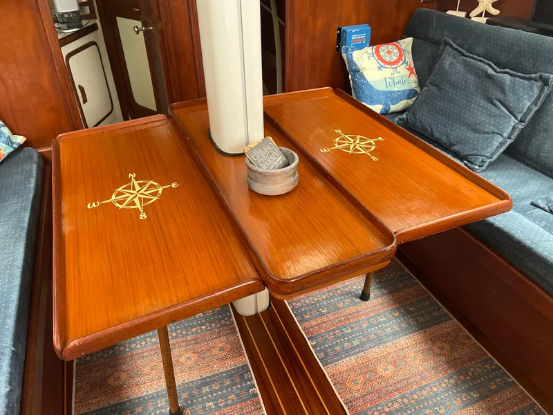 Slide: The Image of 1985 Gulfstar 45 Hirsch Center Cockpit interior with wooden table and compass design. - 19