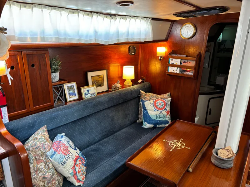 Slide: The Image of Cozy interior of 1985 Gulfstar 45 Hirsch Center Cockpit with nautical decor and wooden furnishings. - 21