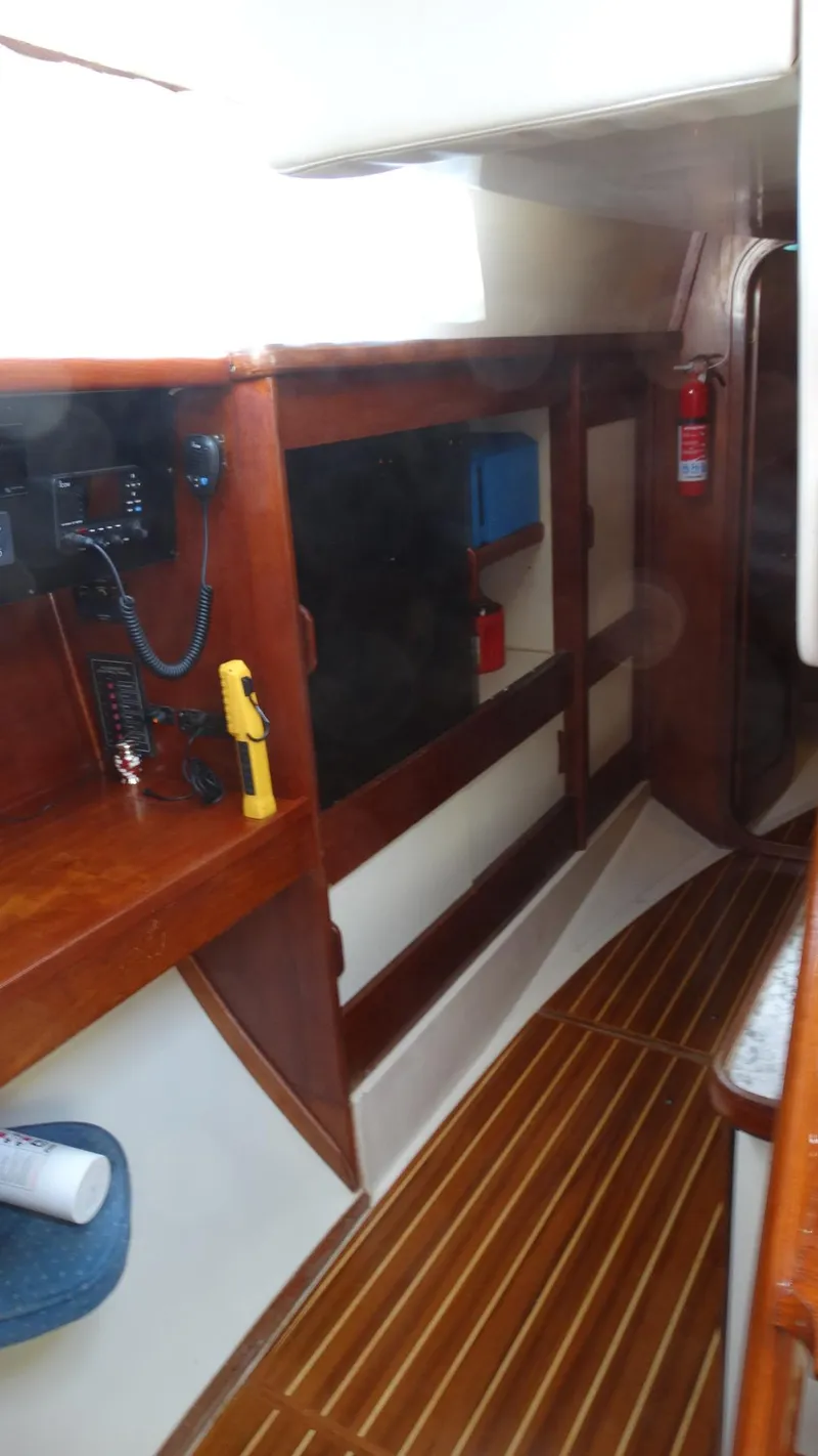 Slide: The Image of 1985 Gulfstar 45 Hirsch Center Cockpit interior with wood paneling and communication equipment. - 22