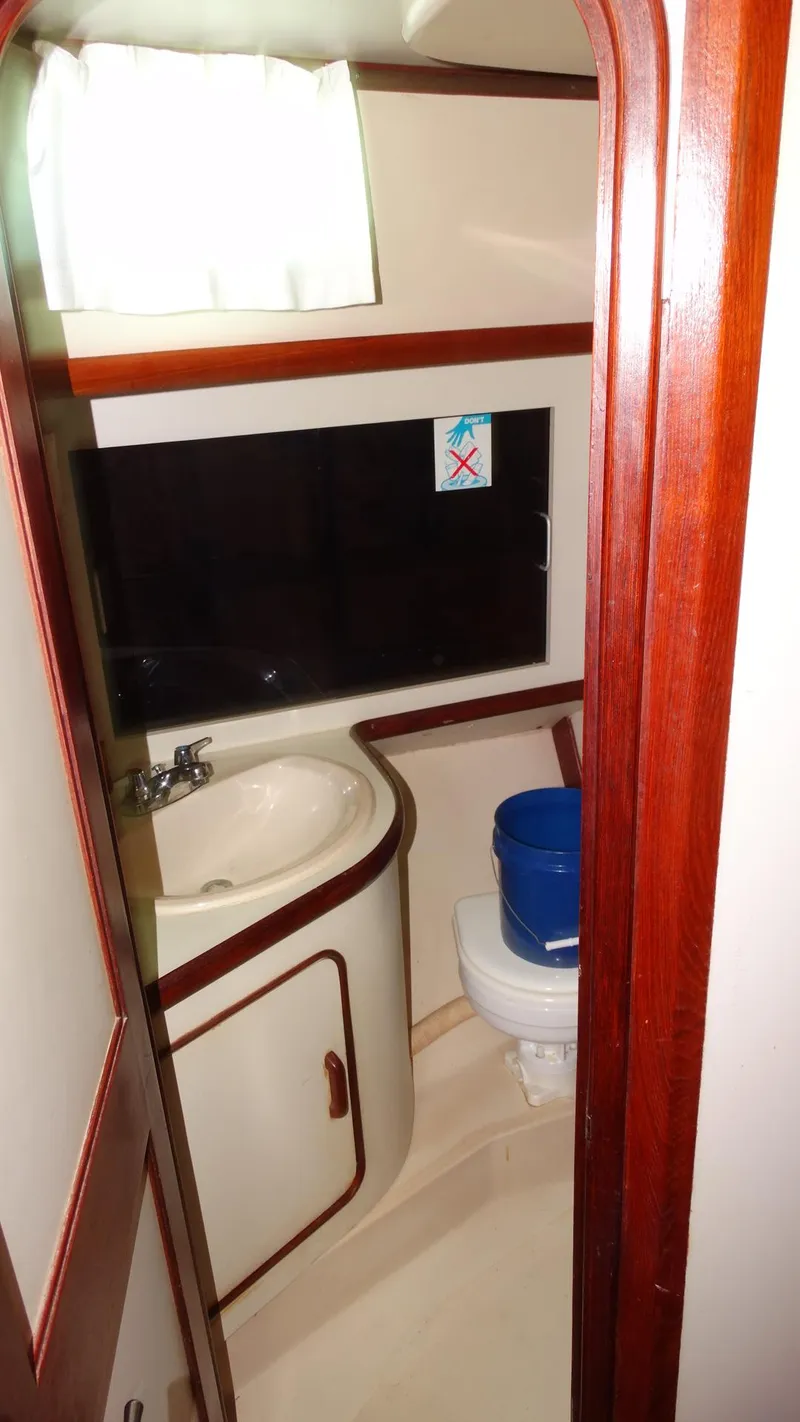 Slide: The Image of 1985 Gulfstar 45 Hirsch Center Cockpit bathroom with sink and toilet. - 23