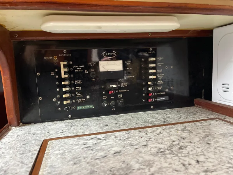 Slide: The Image of Electrical panel of 1985 Gulfstar 45 Hirsch Center Cockpit yacht, featuring various switches and controls. - 27