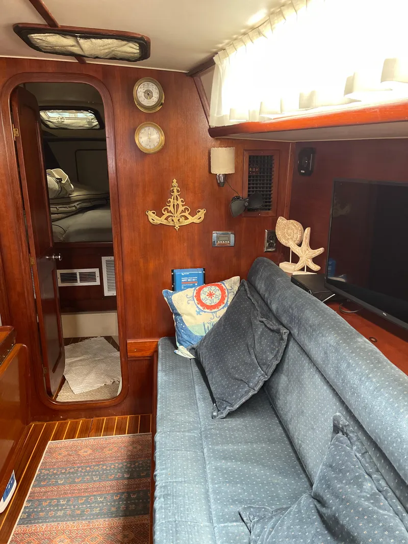 Slide: The Image of Interior of 1985 Gulfstar 45 Hirsch Center Cockpit with cozy seating and nautical decor. - 28