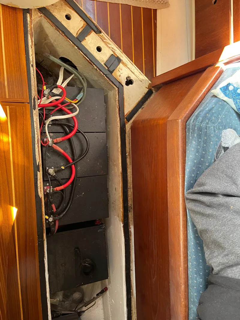 Slide: The Image of Electrical wiring inside 1985 Gulfstar 45 Hirsch Center Cockpit boat, wooden paneling visible. - 37