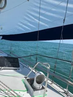 Slide: The Image of 1985 Gulfstar 45 Hirsch Center Cockpit sailboat on open sea, under clear blue sky. - 5