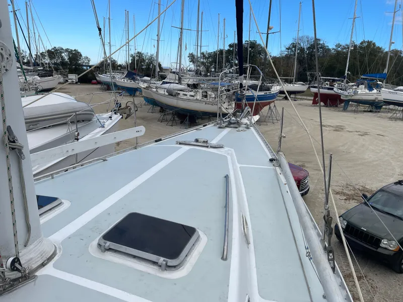 Slide: The Image of 1985 Gulfstar 45 Hirsch Center Cockpit sailboat on land, surrounded by other boats. - 8