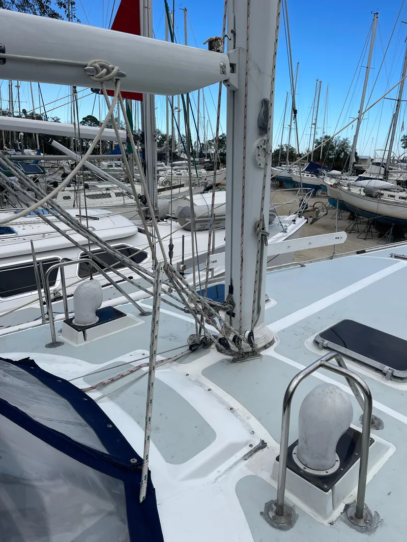 Slide: The Image of 1985 Gulfstar 45 Hirsch Center Cockpit sailboat deck with rigging and marina background. - 9