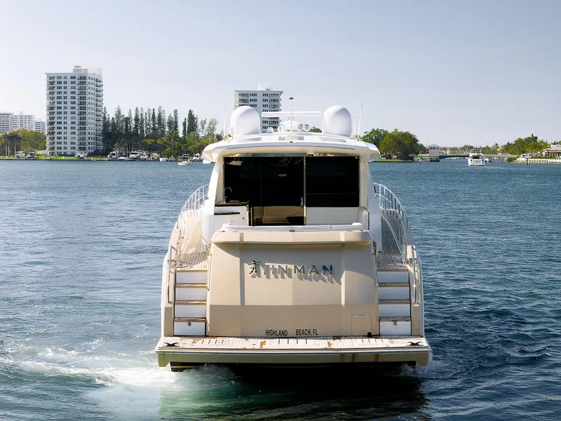 Slide: The Image of 2013 Lazzara LSX yacht cruising on a scenic waterway near modern buildings. - 11