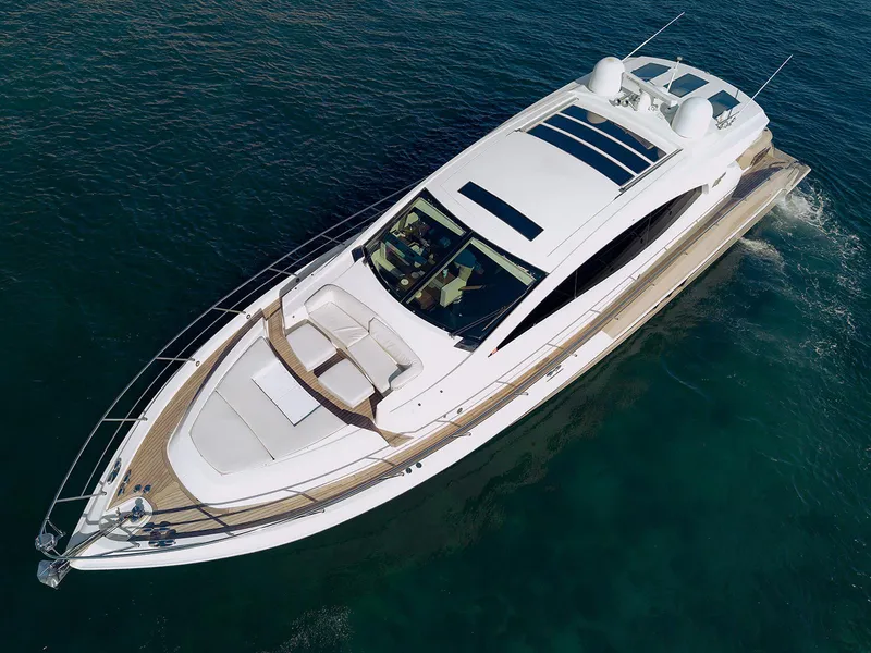 Slide: The Image of 2013 Lazzara LSX yacht cruising on clear blue water, aerial view. - 2