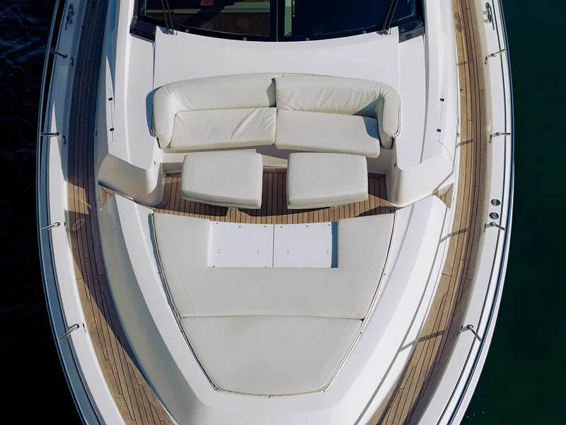 Slide: The Image of 2013 Lazzara LSX yacht deck with white seating and wooden flooring. - 3
