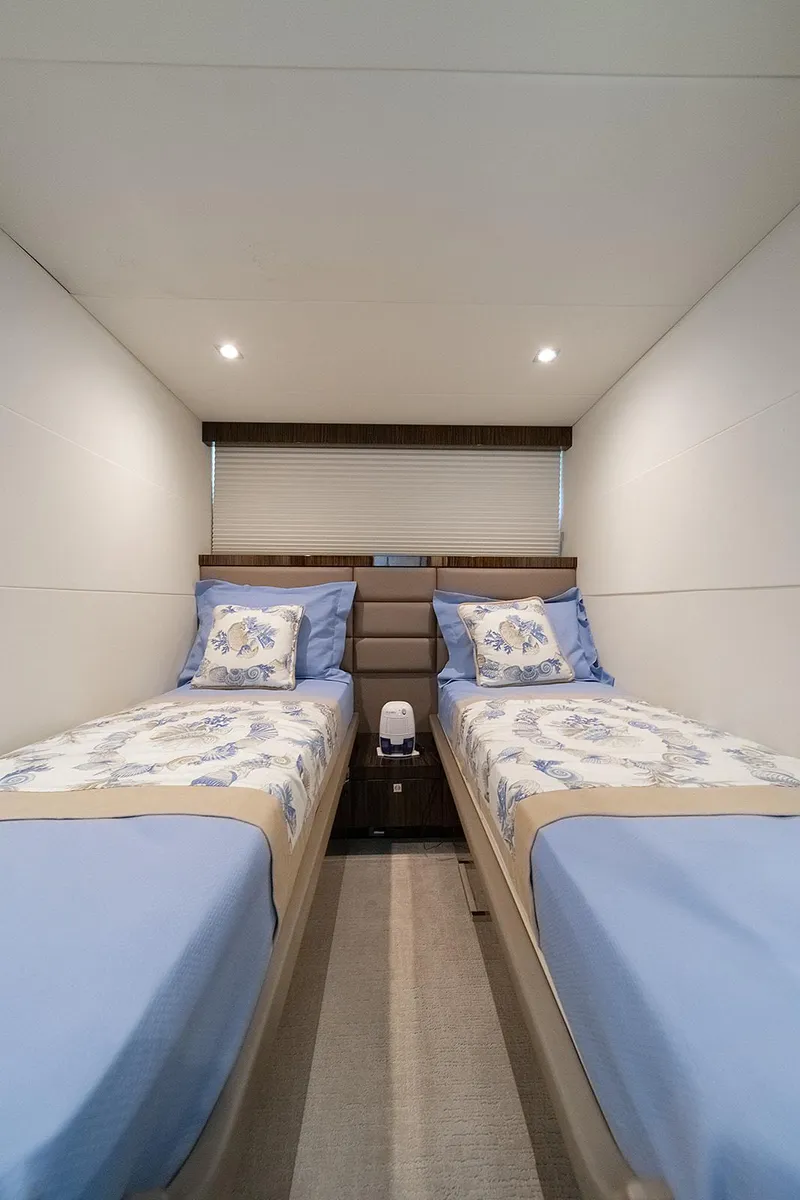 Slide: The Image of Twin beds in a 2013 Lazzara LSX yacht cabin with blue floral bedding. - 41