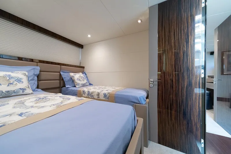 Slide: The Image of Luxurious 2013 Lazzara LSX yacht bedroom with twin beds and elegant decor. - 43