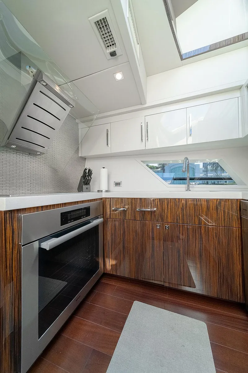 Slide: The Image of Modern kitchen interior in 2013 Lazzara LSX yacht with sleek cabinetry and stainless steel appliances. - 48