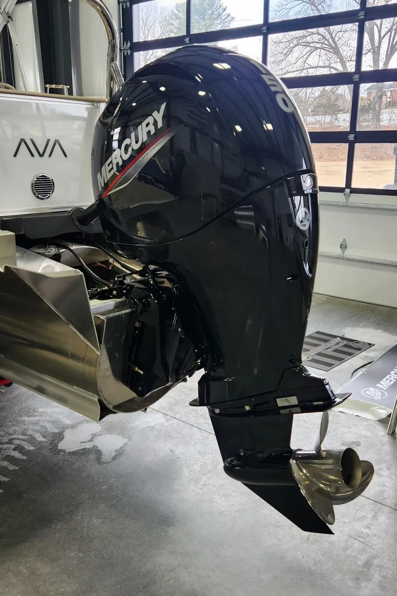 Slide: The Image of 2025 Avalon Platinum LSZ 2185 Cruise Rear Bench with Mercury outboard motor in a showroom. - 12