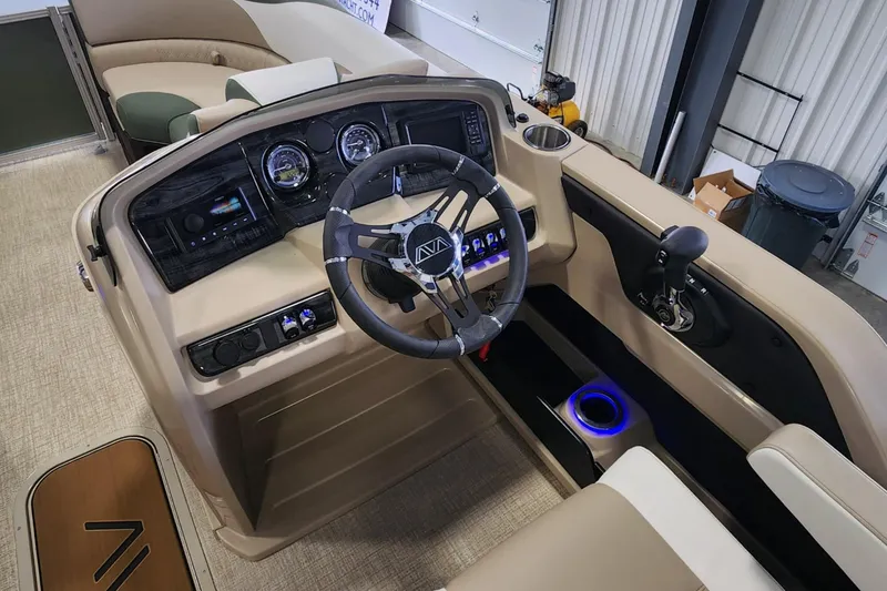 Slide: The Image of 2025 Avalon Platinum LSZ 2185 Cruise Rear Bench boat interior with steering wheel and control panel. - 5