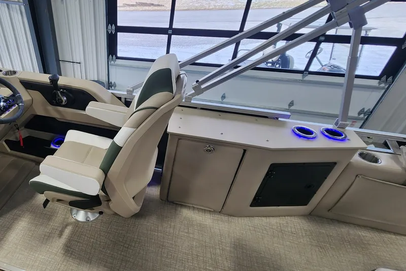Slide: The Image of 2025 Avalon Platinum LSZ 2185 Cruise Rear Bench interior with captain's chair and console. - 6