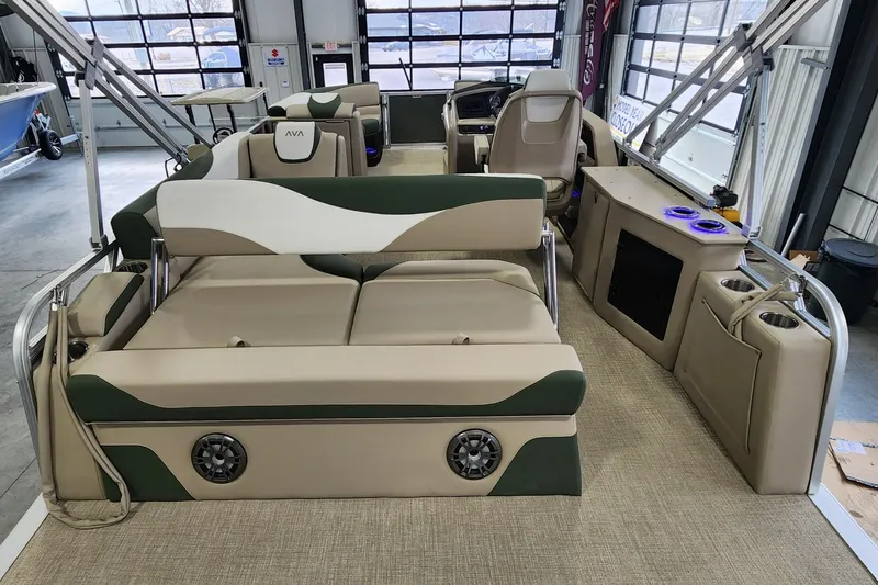 Slide: The Image of 2025 Avalon Platinum LSZ 2185 Cruise Rear Bench with beige and green seating in a showroom. - 9