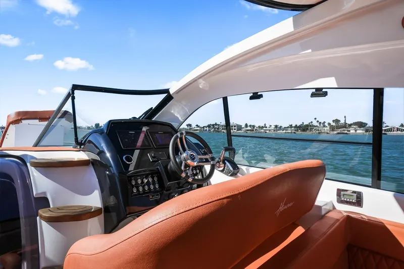 Slide: The Image of 2025 Hanover 355 Outboard boat interior with luxurious seating and modern dashboard. - 13