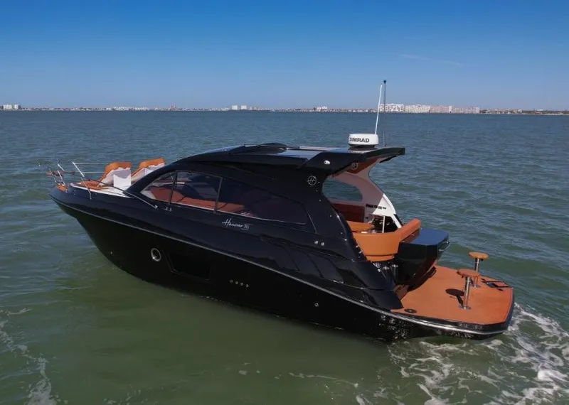 Slide: The Image of 2025 Hanover 355 Outboard luxury boat cruising on open water. - 2