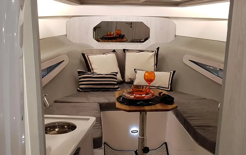 Slide: The Image of 2025 Hanover 355 Outboard cabin interior with cozy seating and elegant decor. - 21